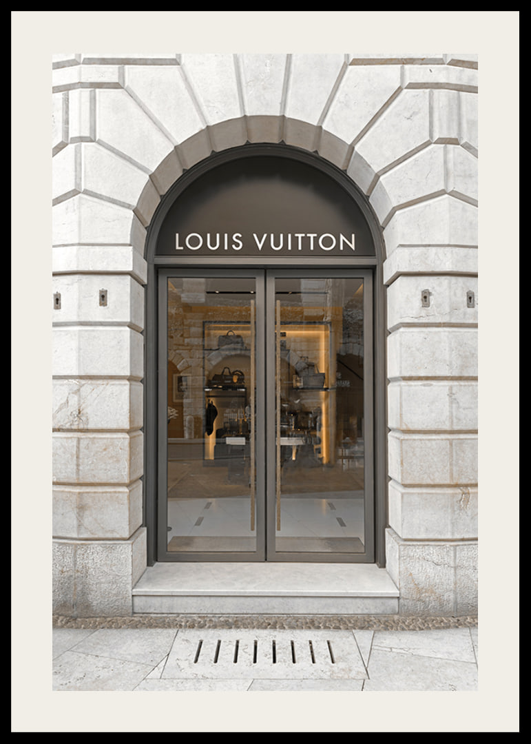 Store entrance with Louis Vuitton sign in stone facade, brown tones-12