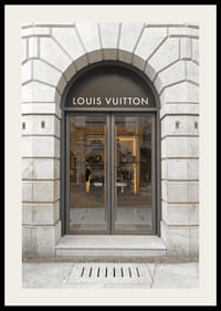 Store entrance with Louis Vuitton sign in stone facade, brown tones-2