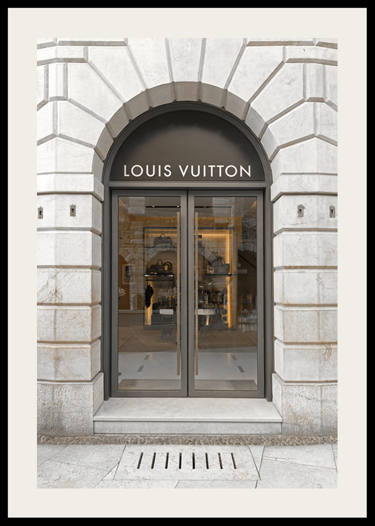 Store entrance with Louis Vuitton sign in stone facade, brown tones-12