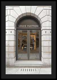 Store entrance with Louis Vuitton sign in stone facade, brown tones-4