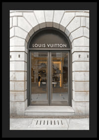 Store entrance with Louis Vuitton sign in stone facade, brown tones-4