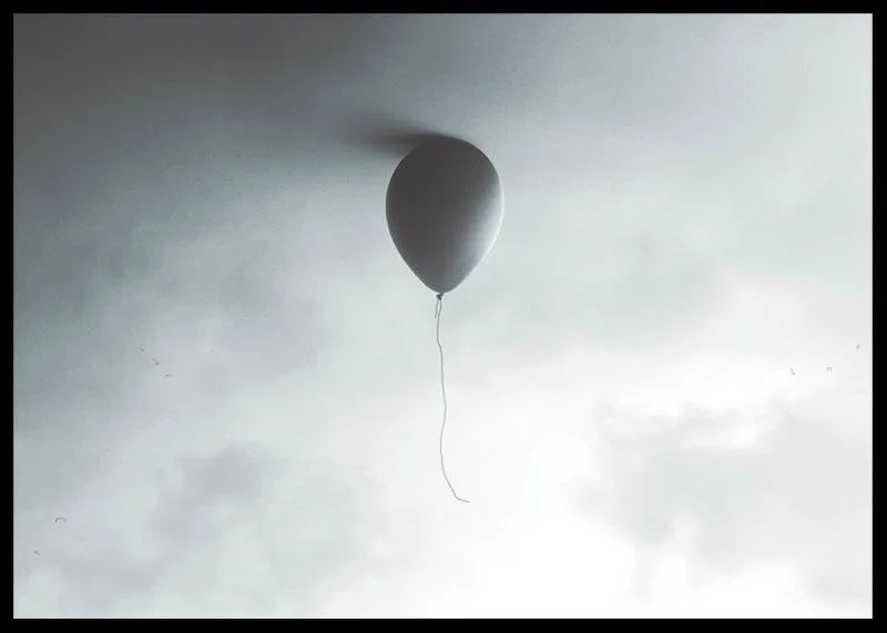 Surreal balloon against light gray sky with clouds-12