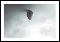 Surreal balloon against light gray sky with clouds-0
