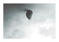 Surreal balloon against light gray sky with clouds-1