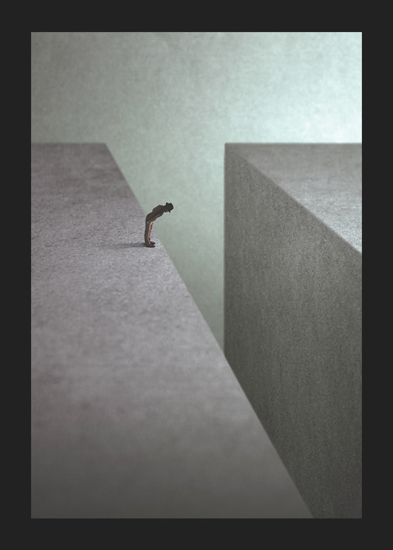 Illustrated man at the edge of wide gorge in gray tones-12