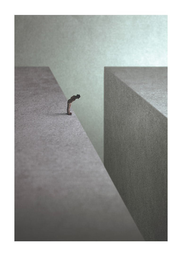 Illustrated man at the edge of wide gorge in gray tones-12
