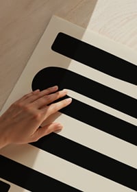 Graphic text illustration with black shapes on beige background-9