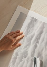 Illustration of person in rowboat above cloud cover-9
