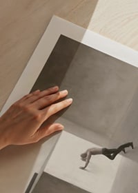 Illustration of man shooting at large cube in empty room-9