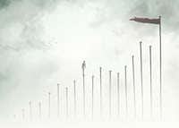 Surreal illustration of man on tall pillars in fog-7