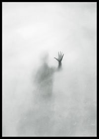 Silhouette of person behind hazy glass in grayscale-6