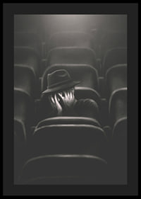 Illustrated man with hat hiding his face in dark cinema hall-0