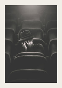 Illustrated man with hat hiding his face in dark cinema hall-5