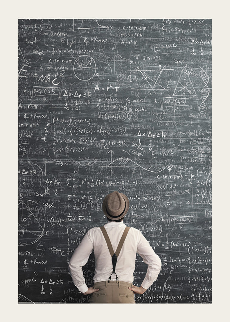 Man i hatt står framför stor griffeltavla med matematiska formler-12