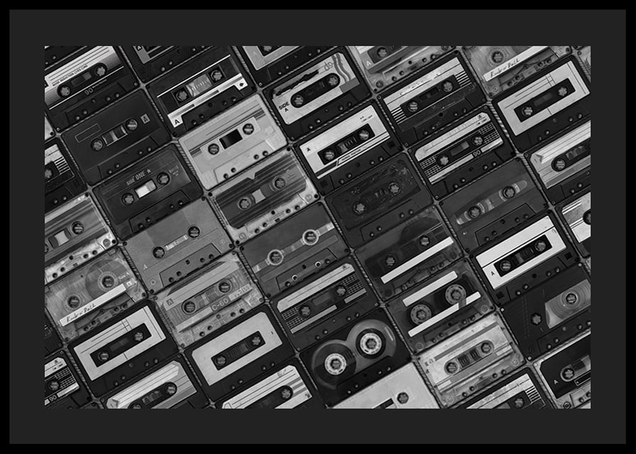 Black and white photograph of several cassette tapes in a checkerboard pattern-12