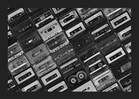 Black and white photograph of several cassette tapes in a checkerboard pattern-1
