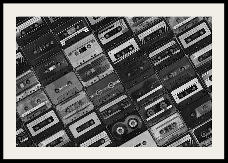 Black and white photograph of several cassette tapes in a checkerboard pattern-12