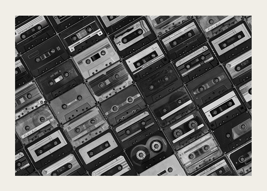 Black and white photograph of several cassette tapes in a checkerboard pattern-12