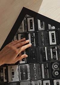 Black and white photograph of several cassette tapes in a checkerboard pattern-9