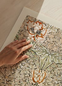 Stylized, dense pattern with honeysuckle flowers and winding leaves in green, yellow and orange shades against a dark background-3