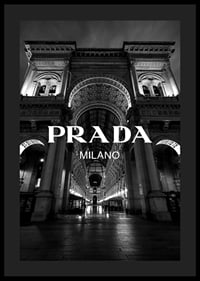 Black and white night image of illuminated arcade in Milan with Prada text-0