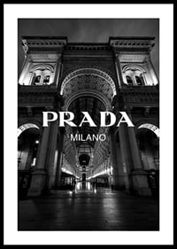 Black and white night image of illuminated arcade in Milan with Prada text-2