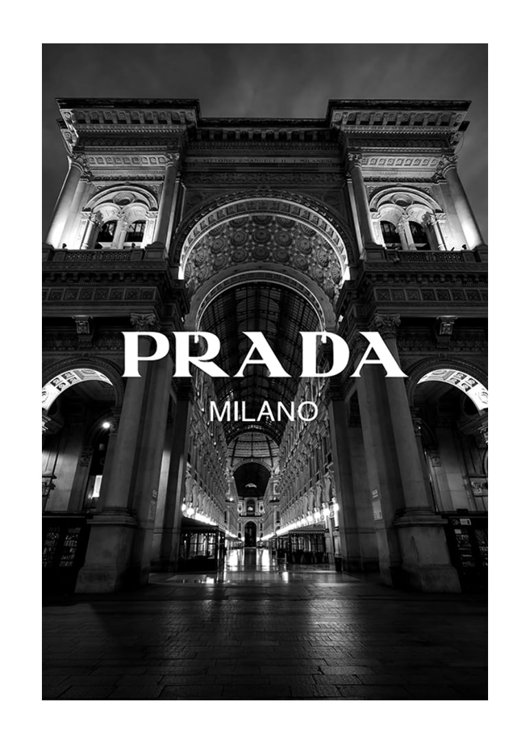 Black and white night image of illuminated arcade in Milan with Prada text-12