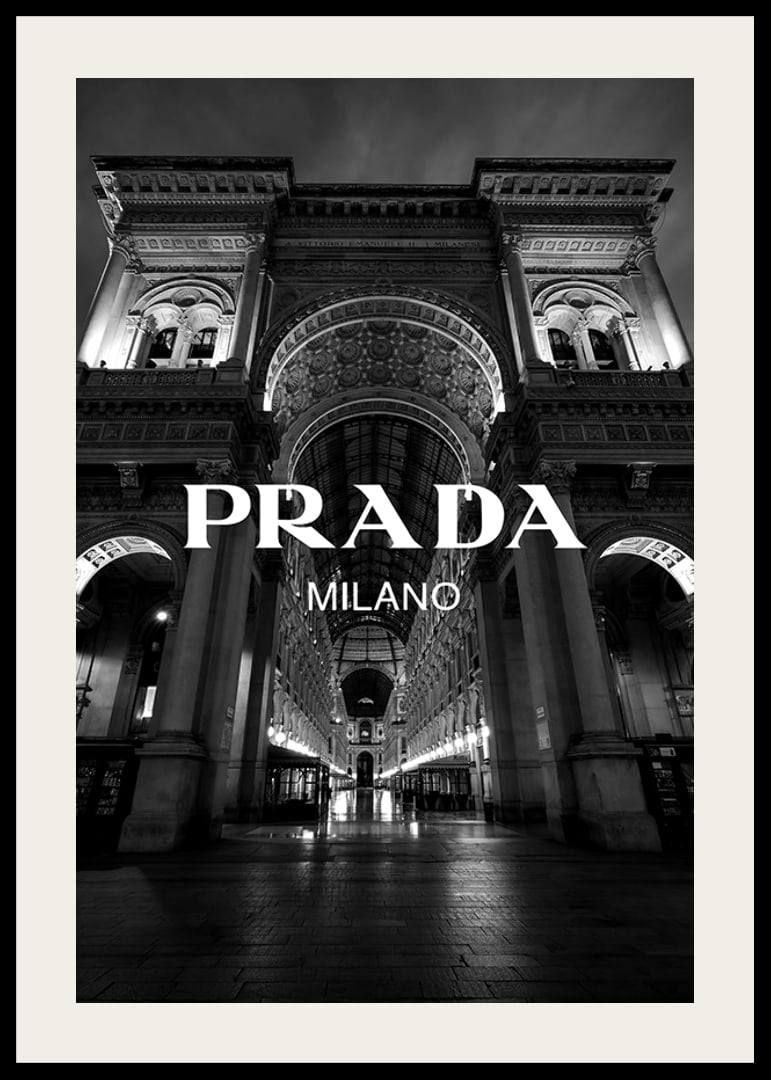 Black and white night image of illuminated arcade in Milan with Prada text-12