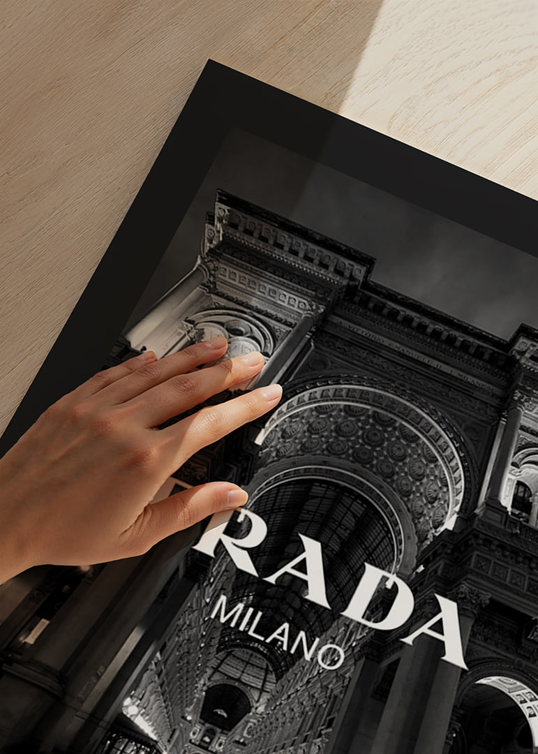 Black and white night image of illuminated arcade in Milan with Prada text-12