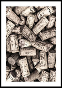Photograph of several wine corks with prints in beige shades-0