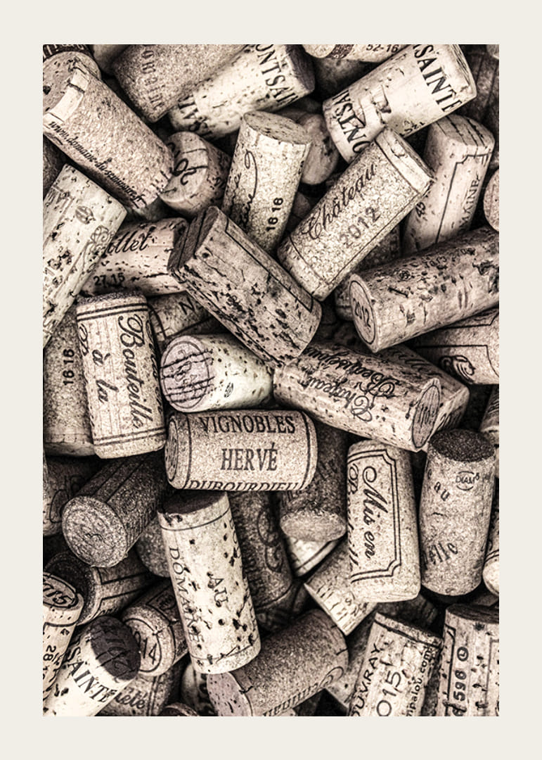 Photograph of several wine corks with prints in beige shades-12