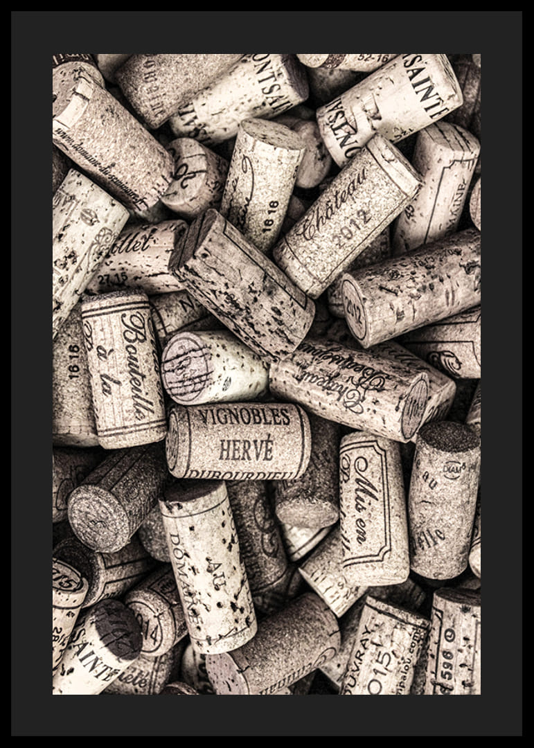 Photograph of several wine corks with prints in beige shades-12