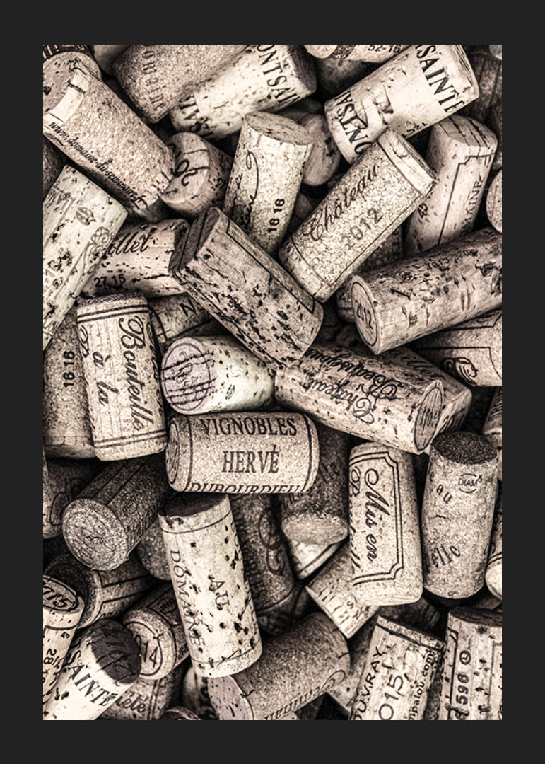 Photograph of several wine corks with prints in beige shades-12