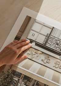 Photograph of Parisian cafe with outdoor seating in beige tones-9