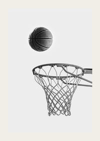 Black and white photo of basketball above basket against light background-3