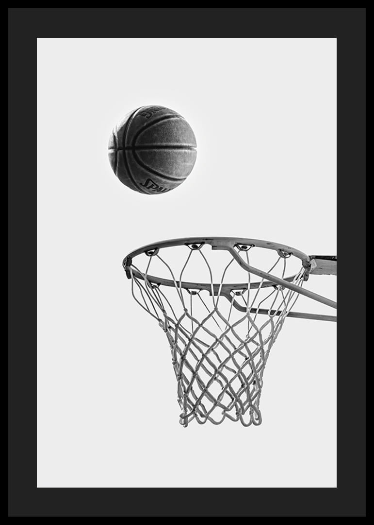 Black and white photo of basketball above basket against light background-12