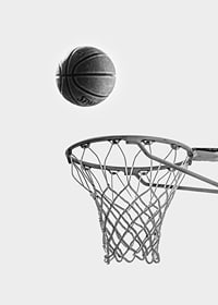 Black and white photo of basketball above basket against light background-7