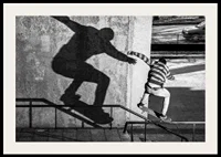 Black and white photo of skateboarder climbing railing outdoors-2