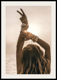 Nő a levegőbe emelt karokkal, kagylókarkötővel és háttérvilágítással a tengerparton-2