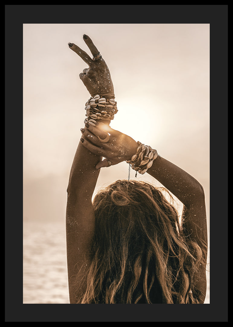 Woman with arms in the air, shell bracelet and backlight by the sea-12