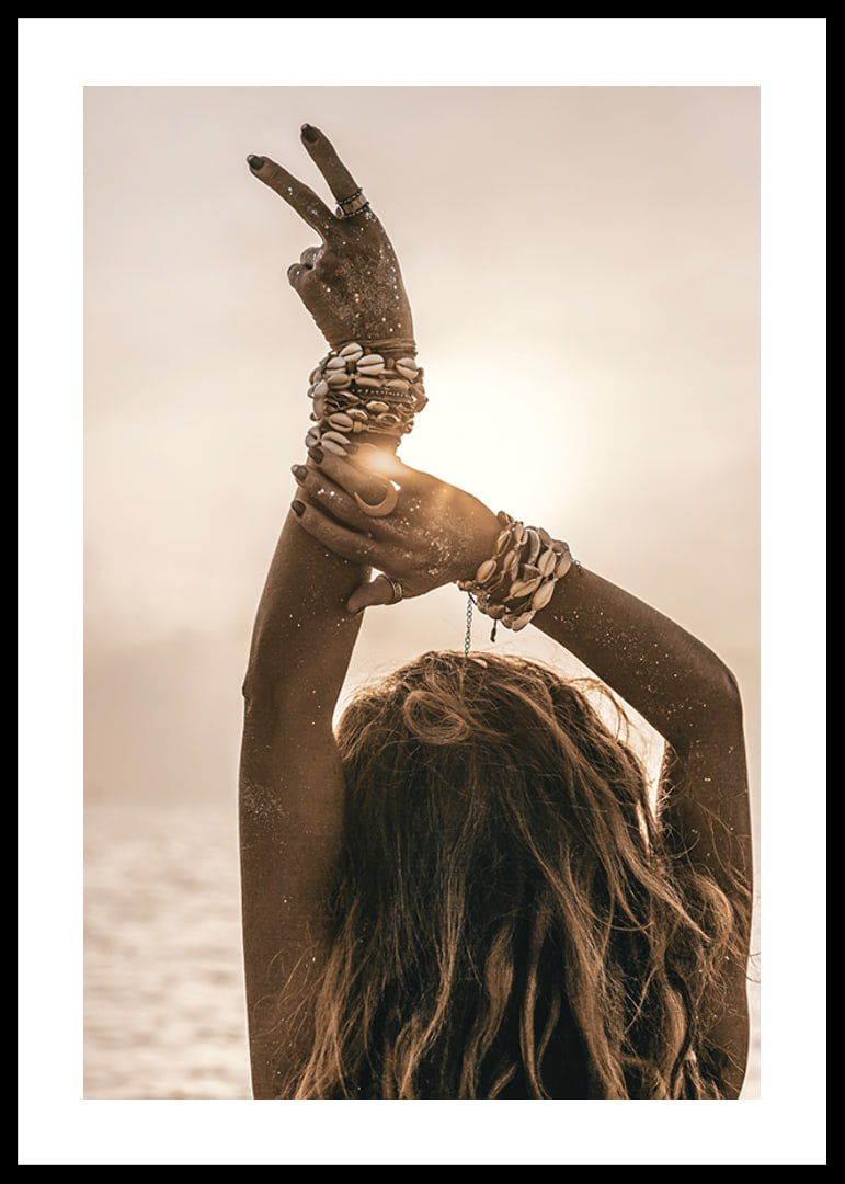 Woman with arms in the air, shell bracelet and backlight by the sea-12