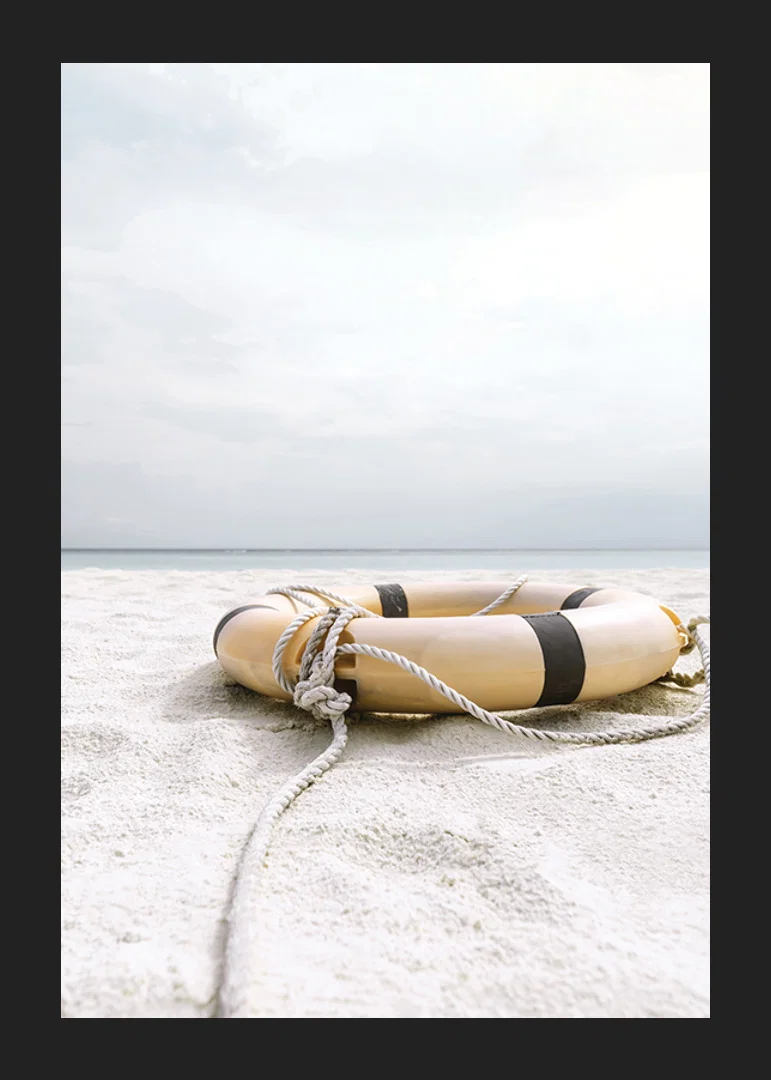 Photograph of lifebuoy on light sandy beach with ocean in the background-12