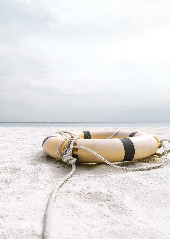 Photograph of lifebuoy on light sandy beach with ocean in the background-12