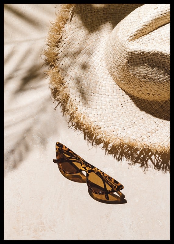 Photographic close-up of straw hat and patterned sunglasses-12