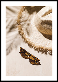 Photographic close-up of straw hat and patterned sunglasses-0