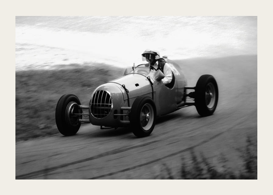 Black and white photography of classic racing car in motion-12