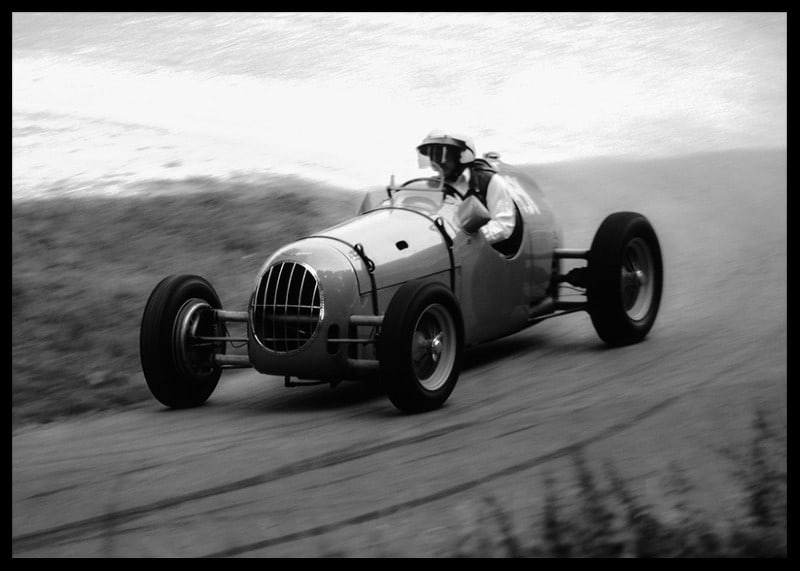Black and white photography of classic racing car in motion-12