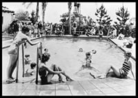 Black and white photo of pool party with bathers and spectators, 1930s-6