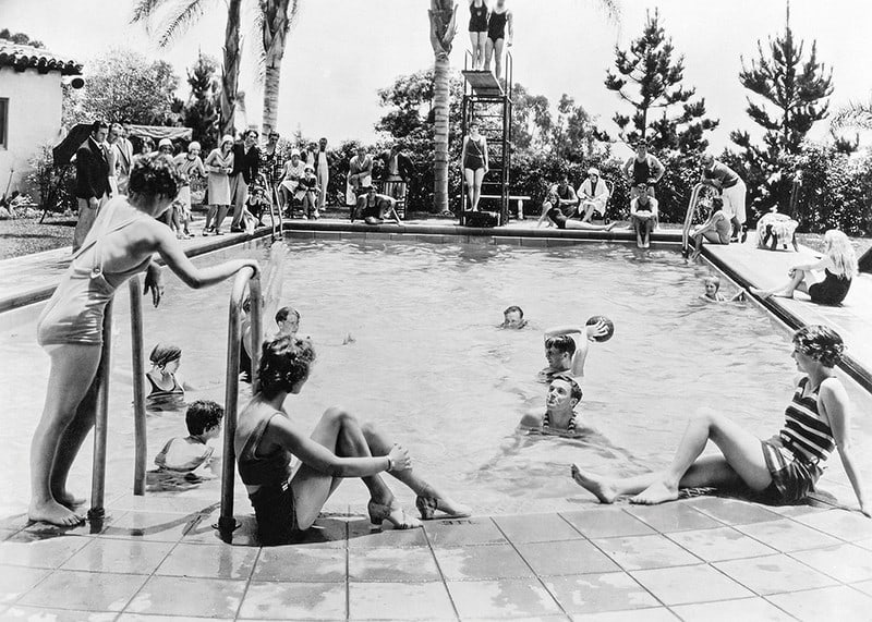 Black and white photo of pool party with bathers and spectators, 1930s-12