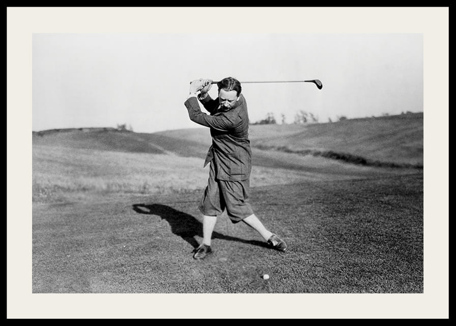 Black and white photograph of male golfer in classic attire-12